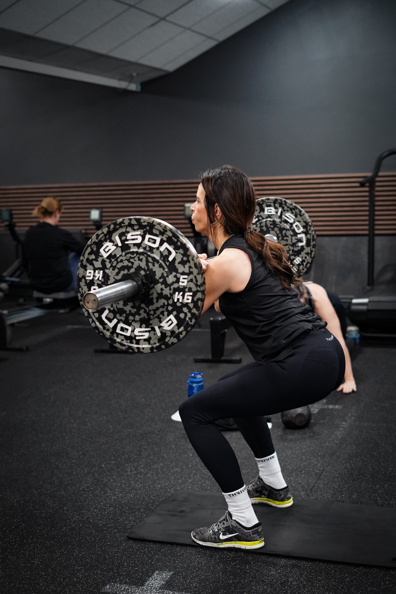 Member performing barbell back squat